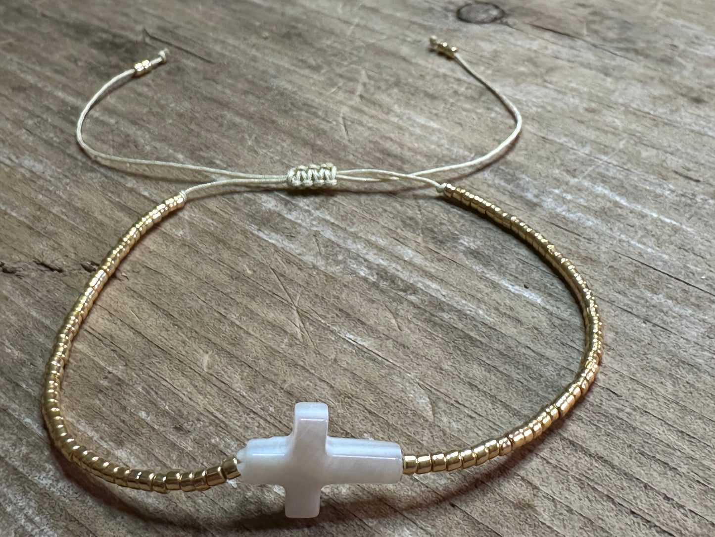 Cute4Girls White Cross: Gold-Plated Beaded Bracelet featuring a White Cross charm, adjustable boho style.